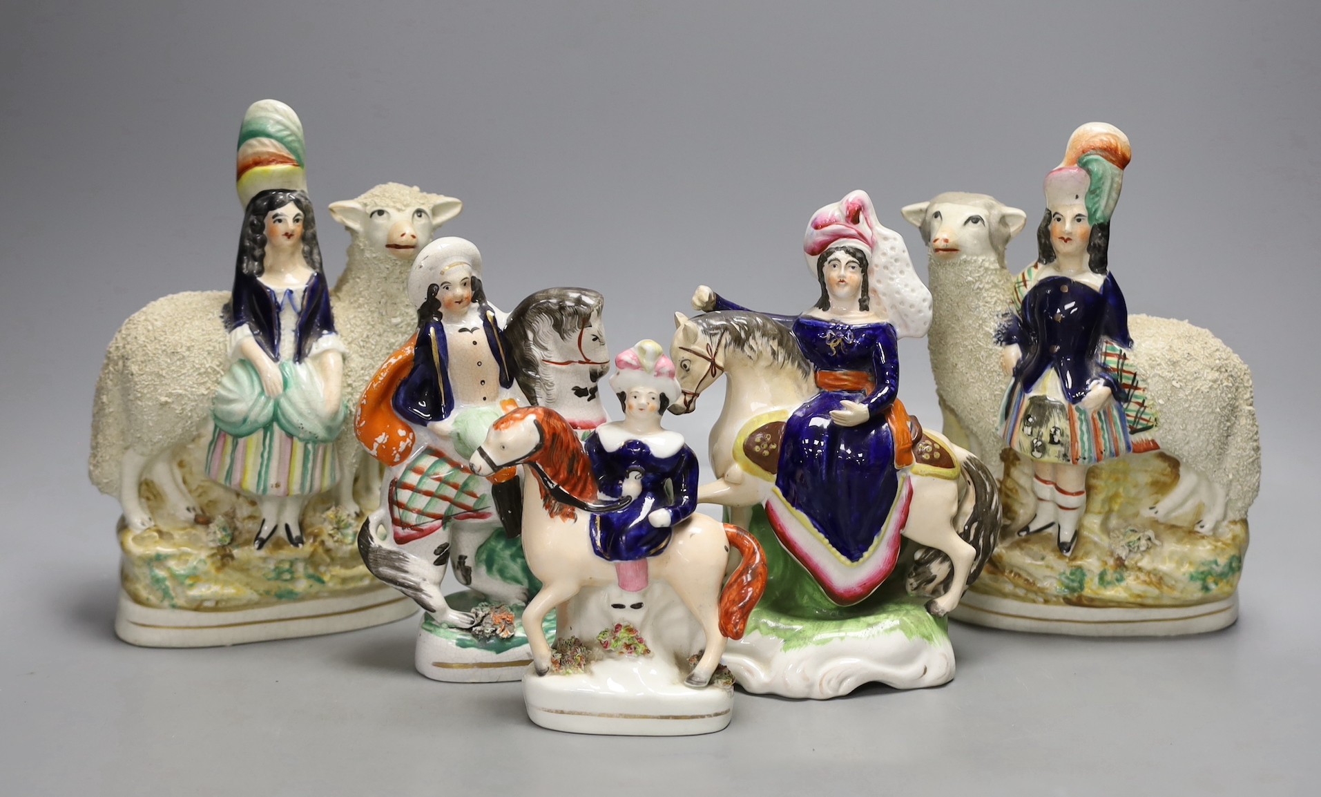 A pair of 19th century Staffordshire sheep and children groups and three Staffordshire pottery and equestrian groups - tallest 22.5cm